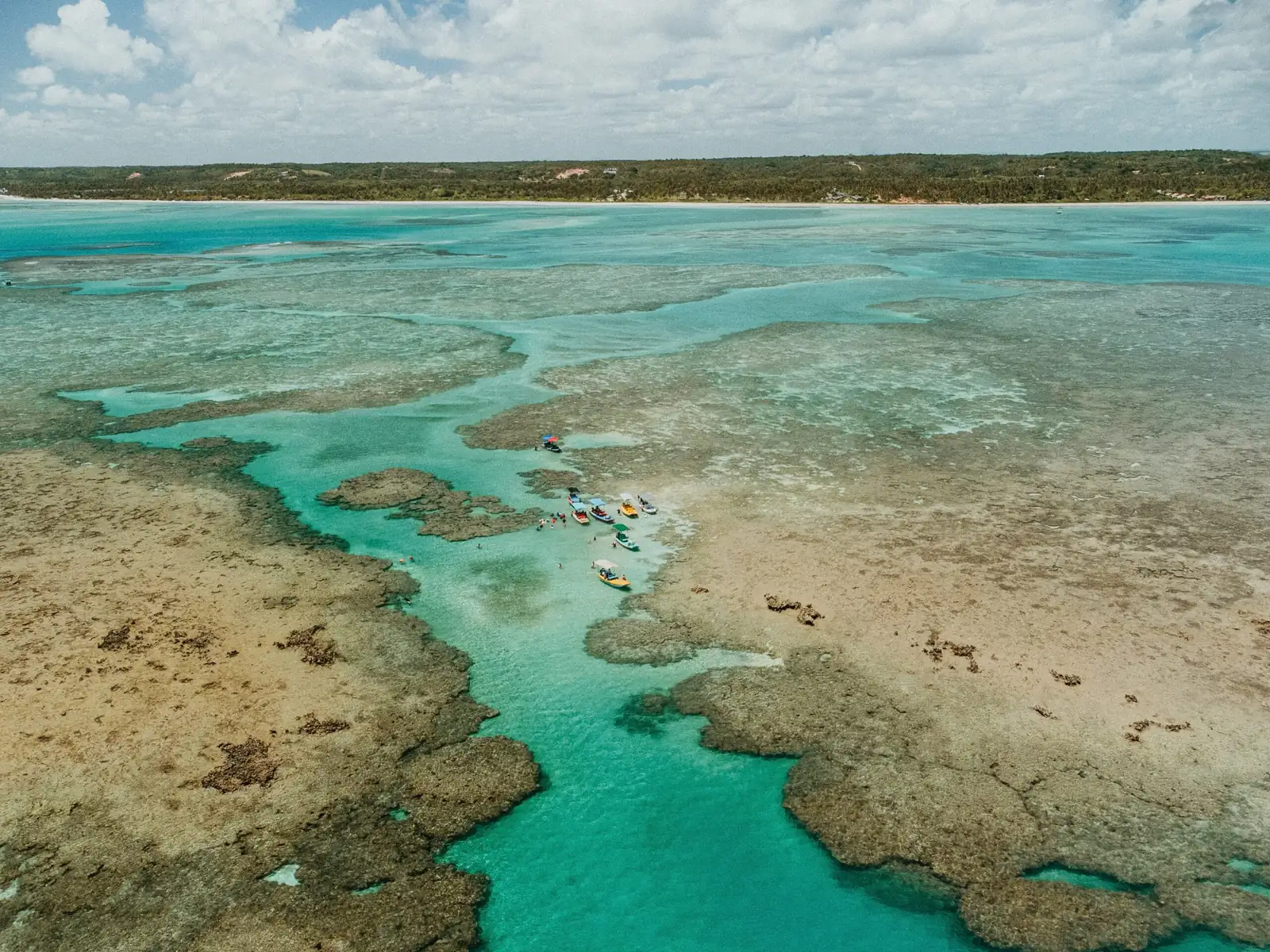 Aerial view of the reefs and natural pools of the Costa dos Corais, with boats, in Alagoas