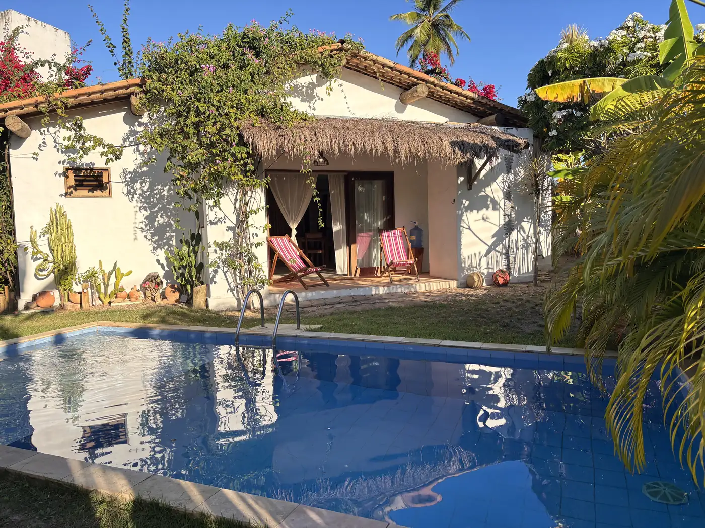 Casa de praia do Pontal da Enseada com varanda voltada para a piscina e o jardim, em Tatuamunha